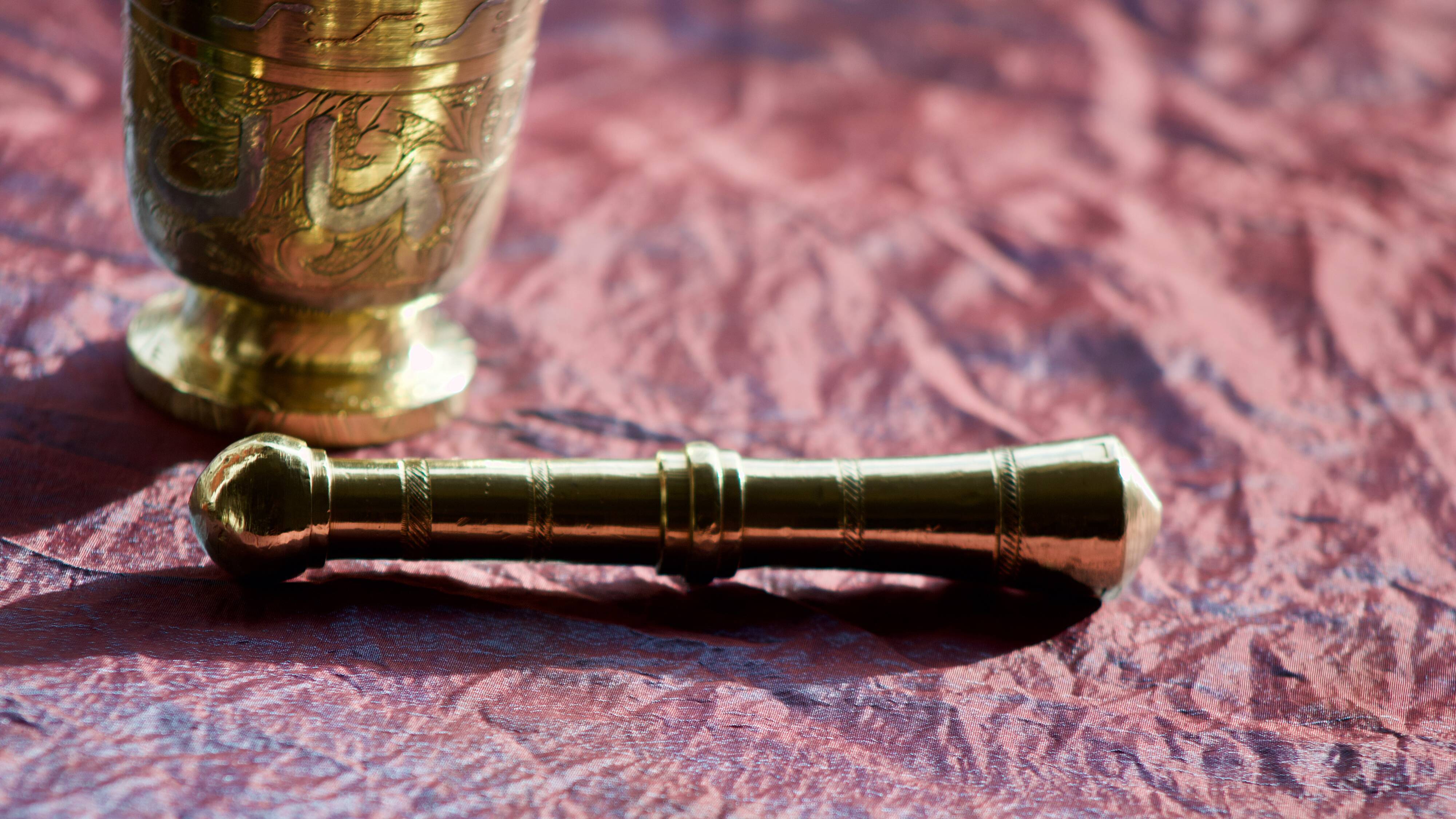 Mortar and its brass pestle with oriental gold and silver motifs