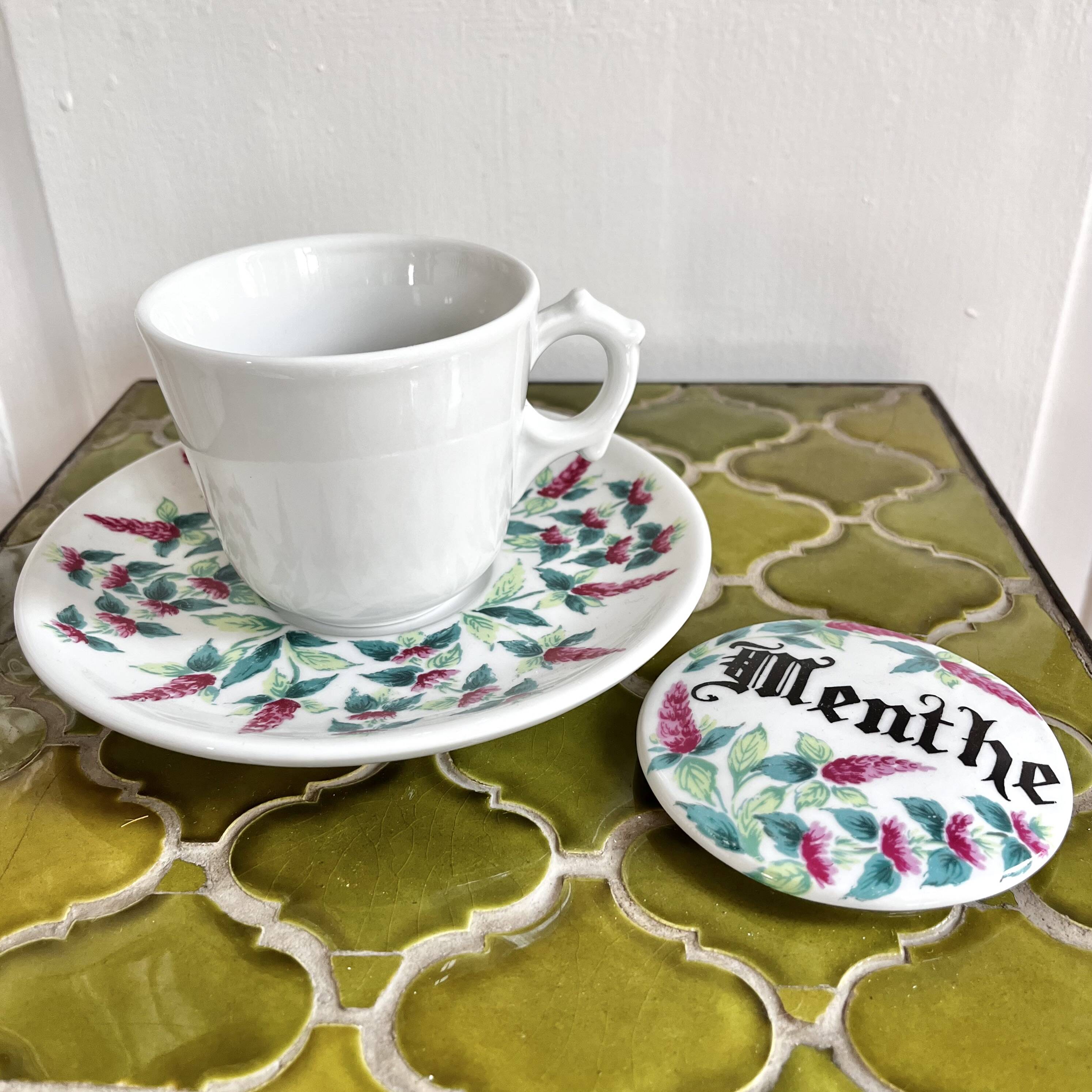 Antique herbal tea cup with mint infusion