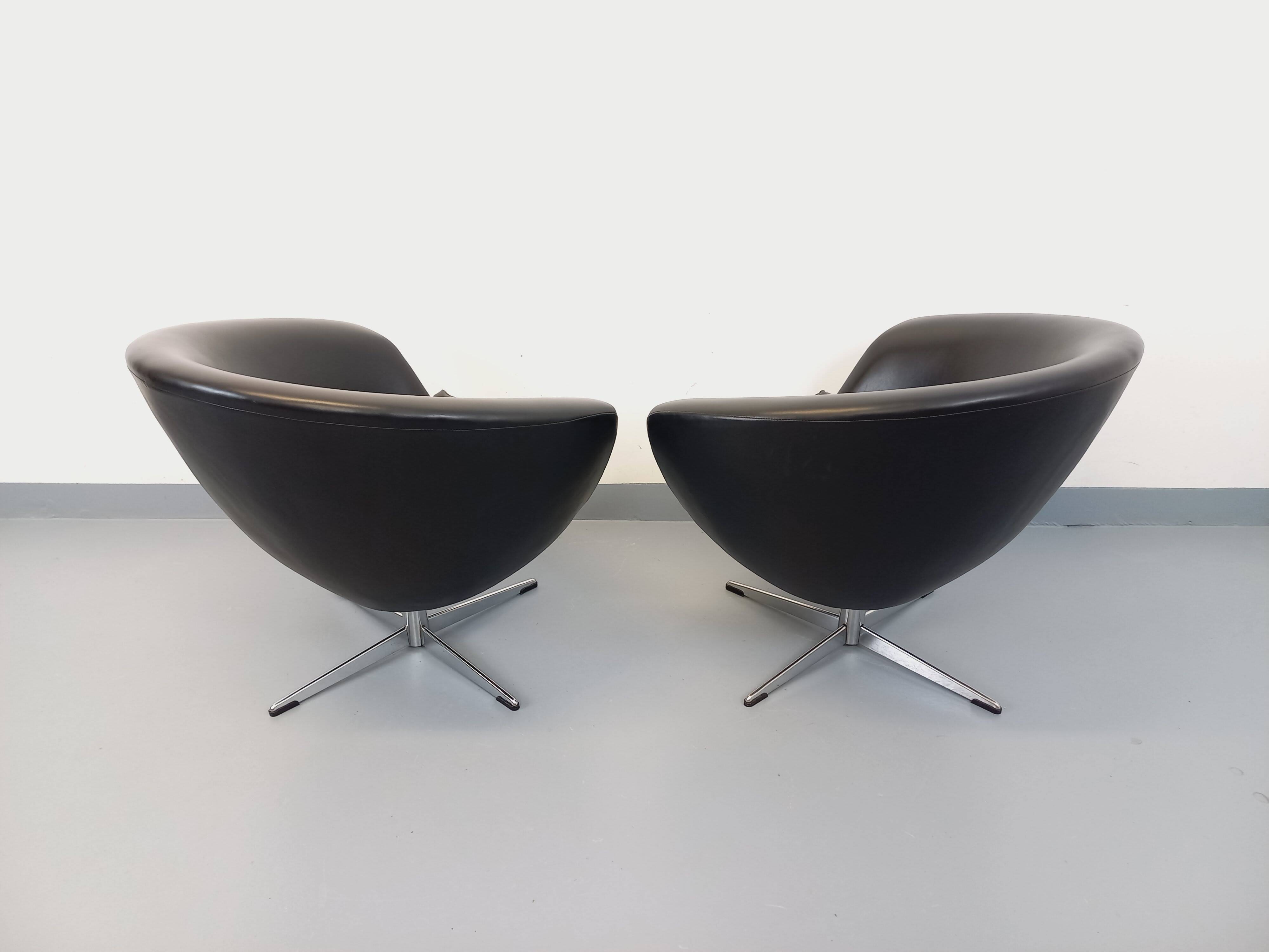 Pair of vintage Scandinavian swivel armchairs in faux leather and chrome.