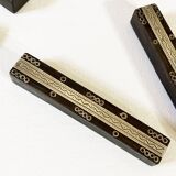 Set of 11 ebony wood knife rests with brass inlay