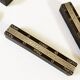 Set of 11 ebony wood knife rests with brass inlay