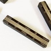 Set of 11 ebony wood knife rests with brass inlay