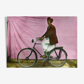 Portrait of a man on his bike, Rajasthan around 1920, old colored photograph