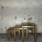 Trio of nesting tables, brass structures and smoked mirror tops