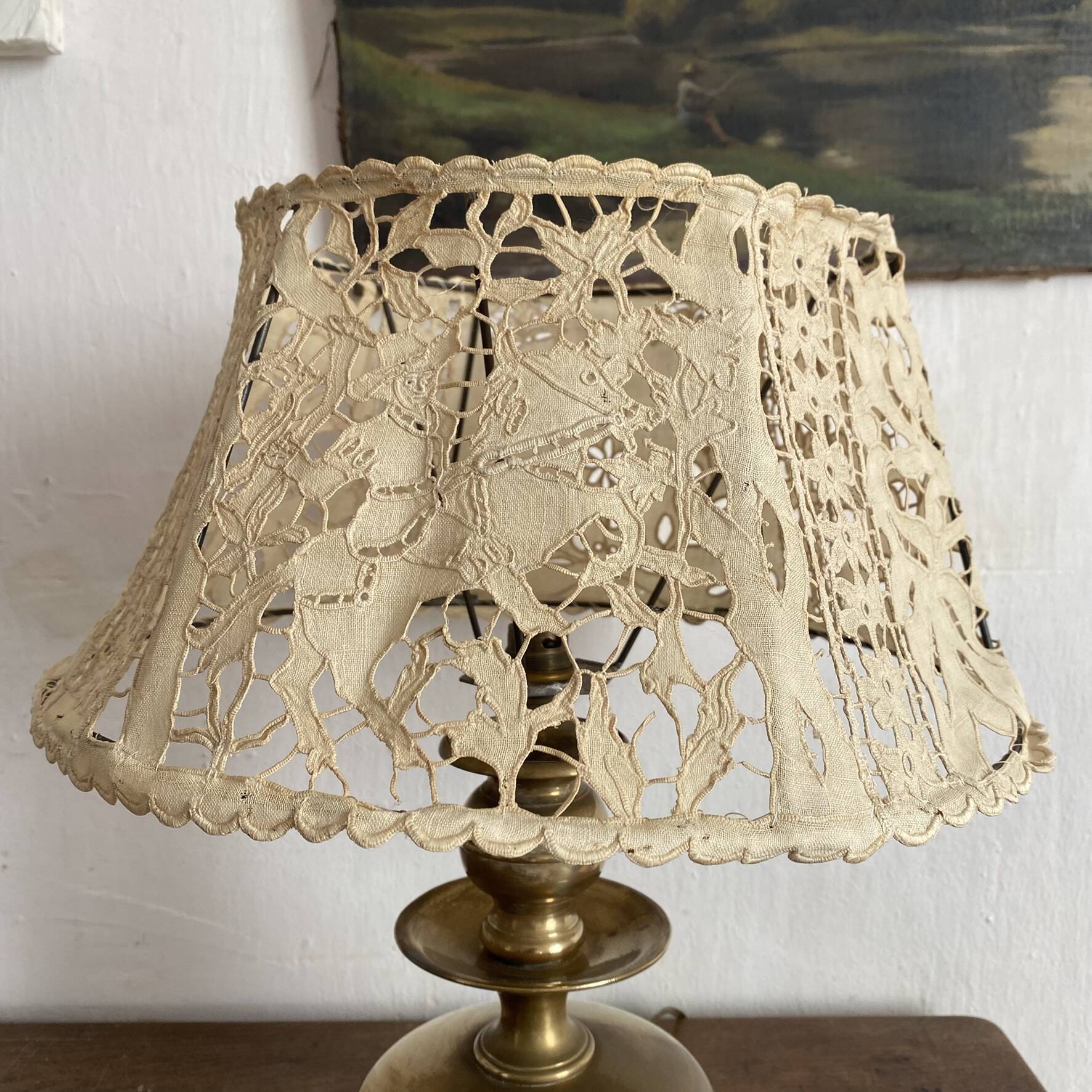 Antique brass lamp with embroidered openwork shade.