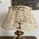 Antique brass lamp with embroidered openwork shade.