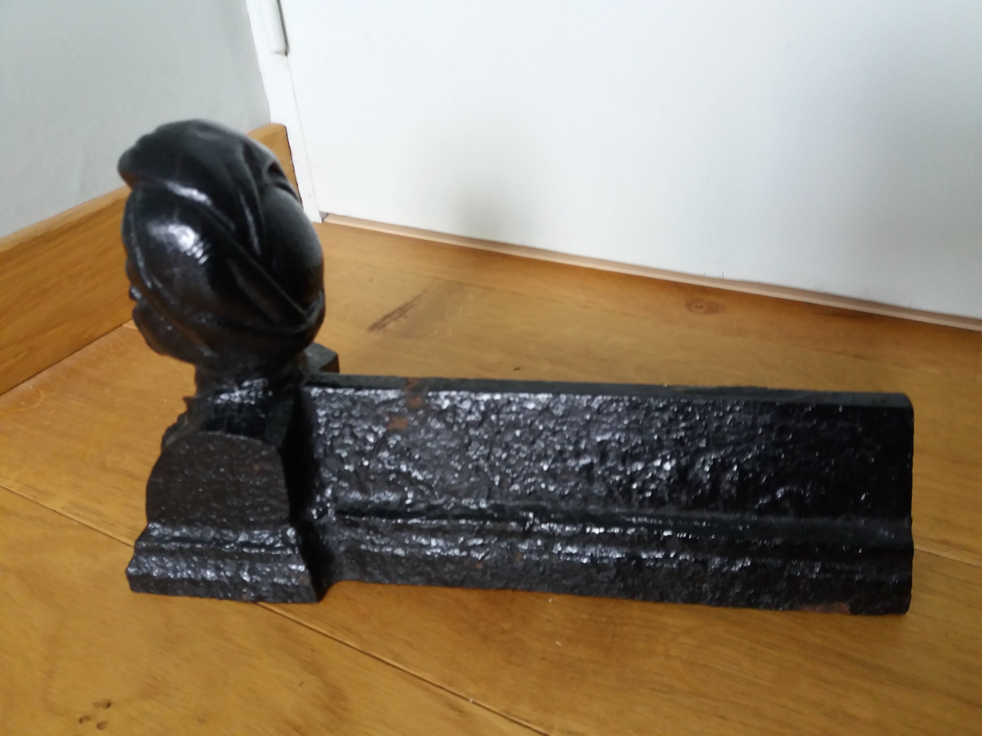 Cast iron andirons with character heads