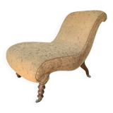 Antique brown recamier armchair in fabric and wood, S-shaped silhouette and turned legs.