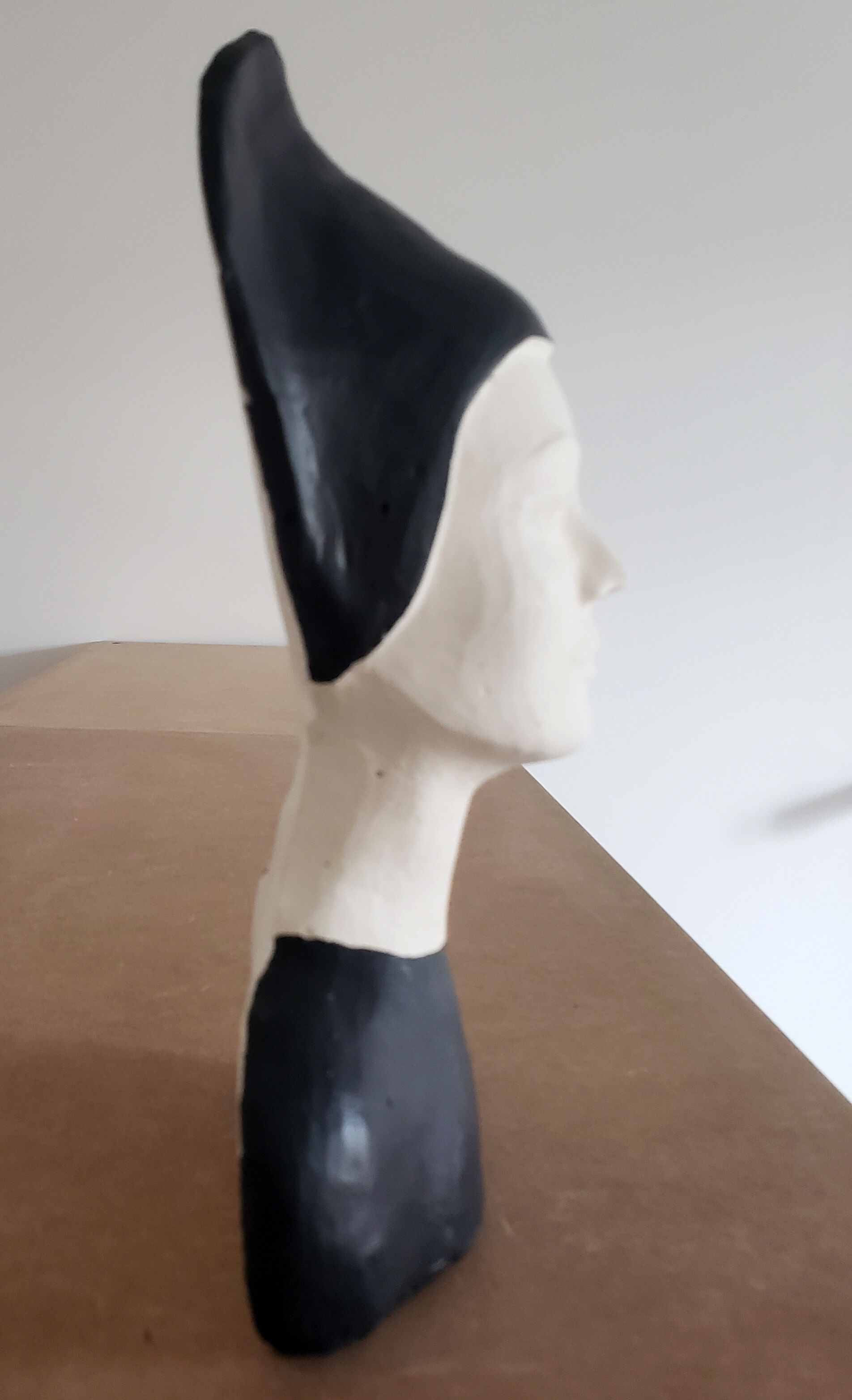 Bust of a woman in anthracite and white plaster