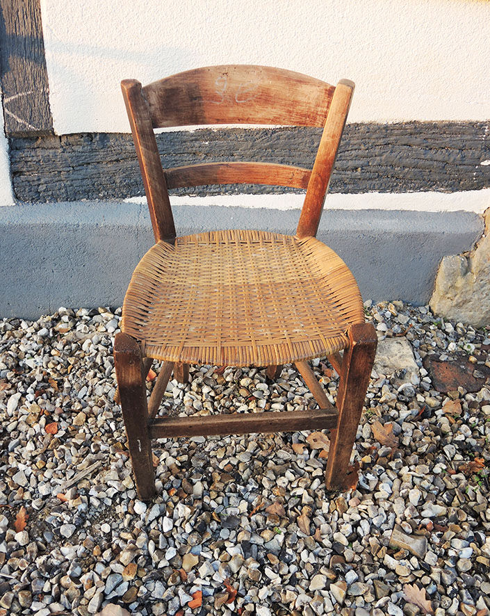 Old woven straw children's chair
