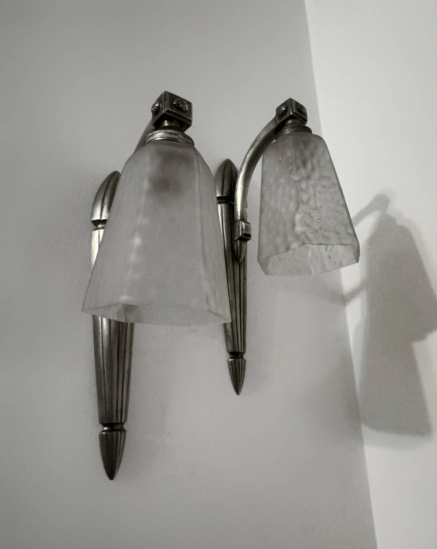 Silver Art Deco wall lights with frosted glass.