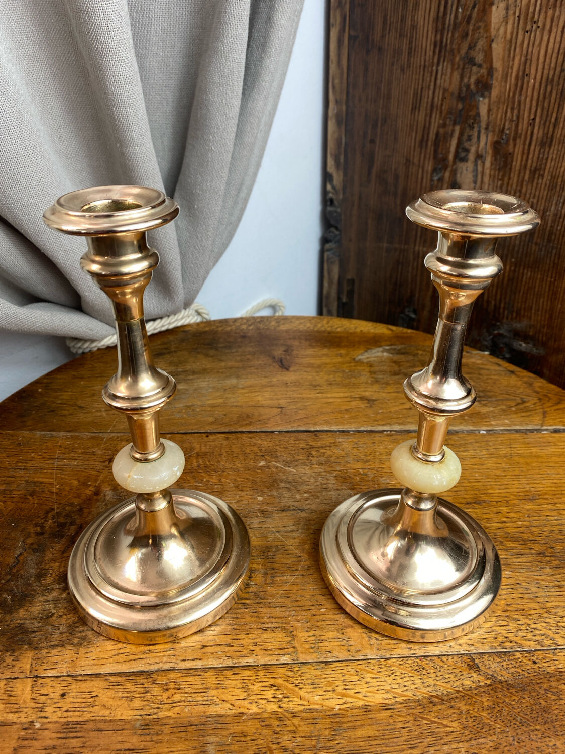 Pair of brass and stone candlesticks