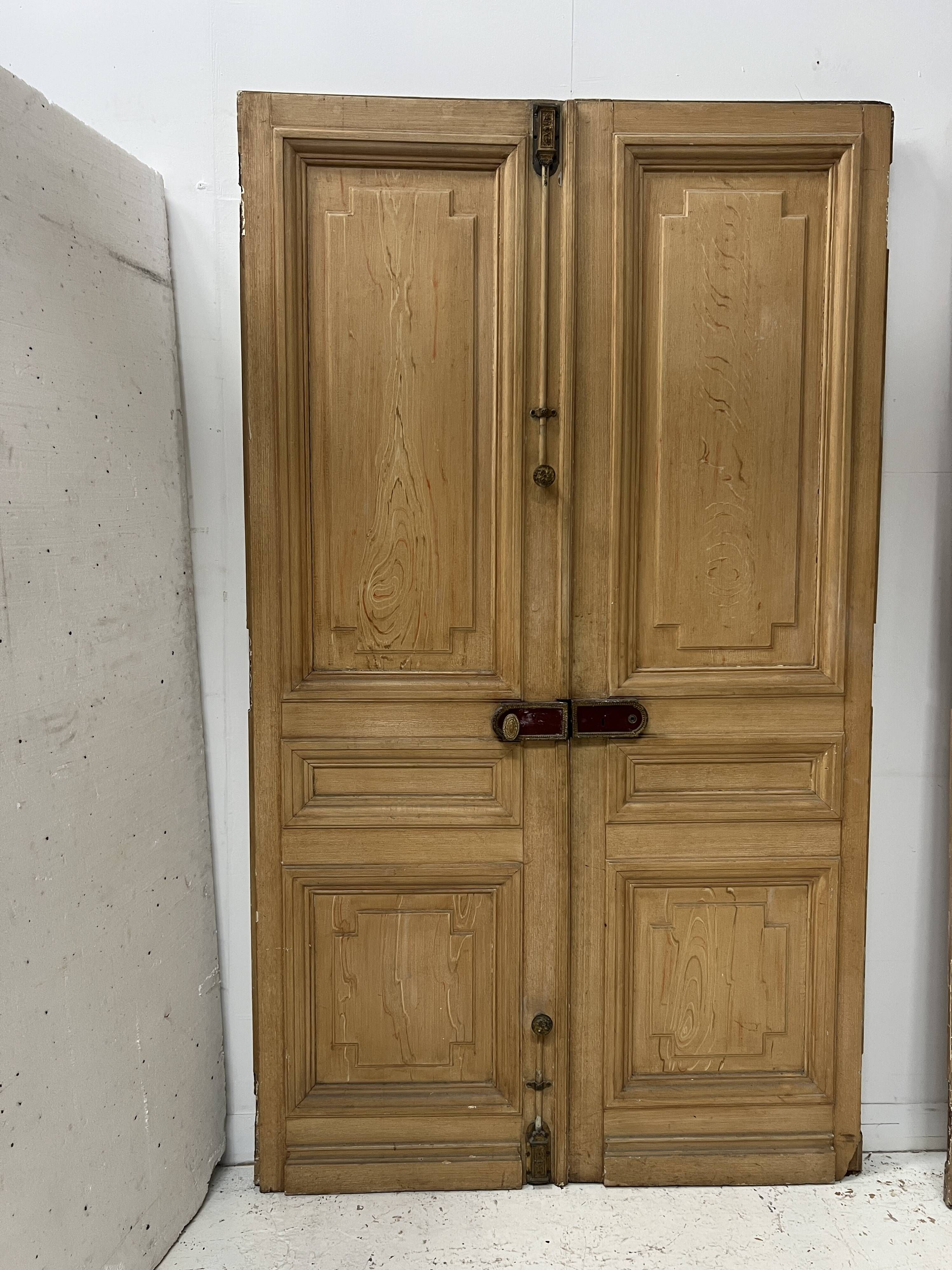 Pair of Haussmann-style double passage doors in patinated oak from the 19th century.