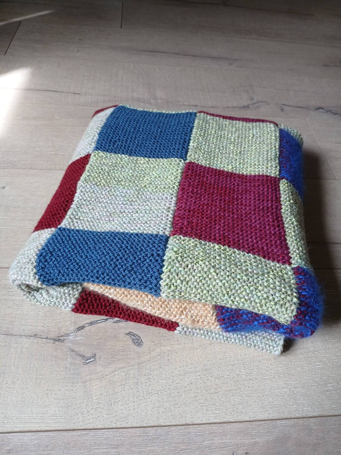 Hand knitted patchwork plaid
