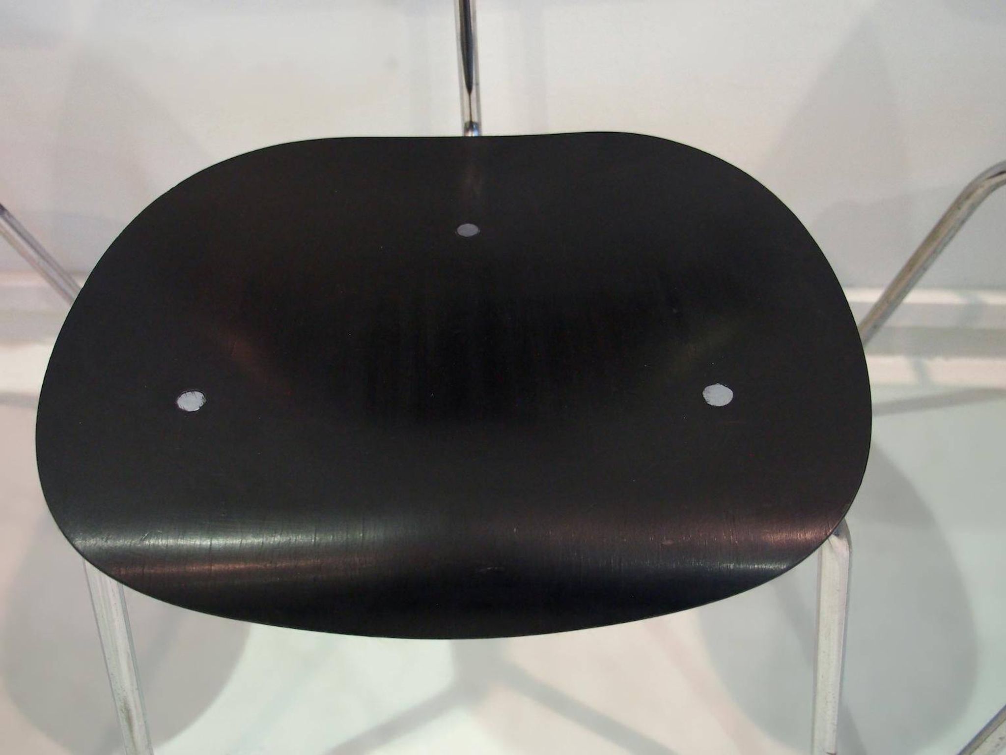 Set of four Egon Eiermann model SE 68 chairs in black lacquered plywood and steel.
