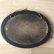 Old oval mirror with wooden frame