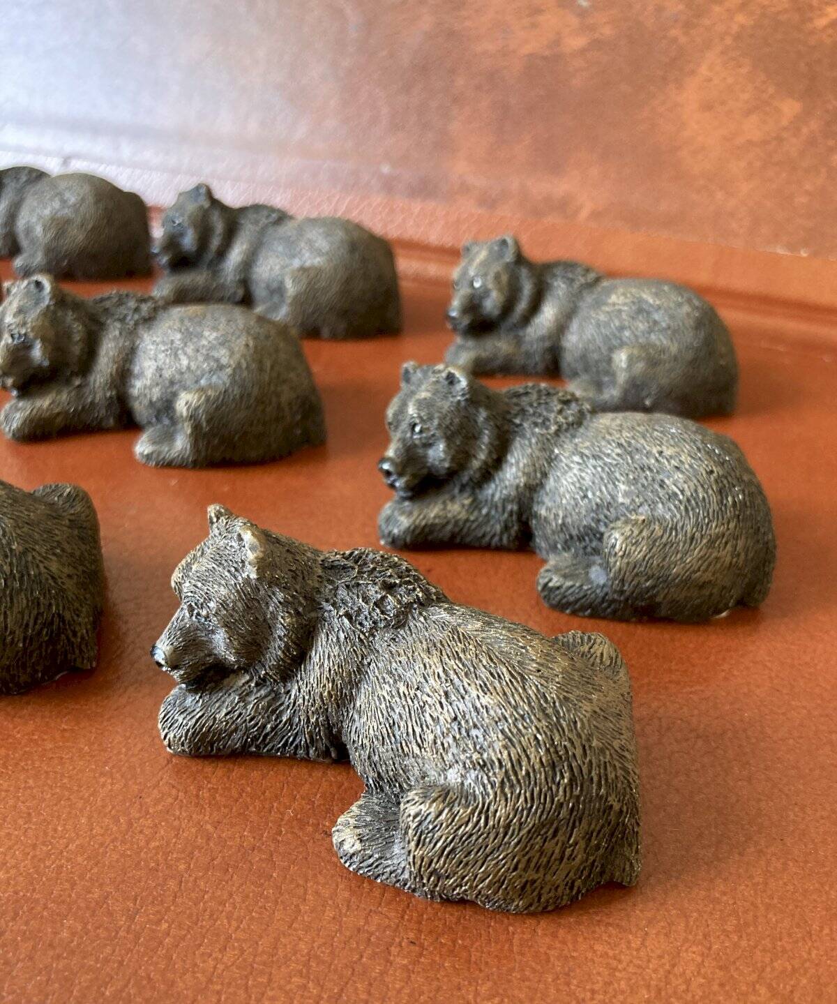 12 elongated brown bear-shaped knife rests