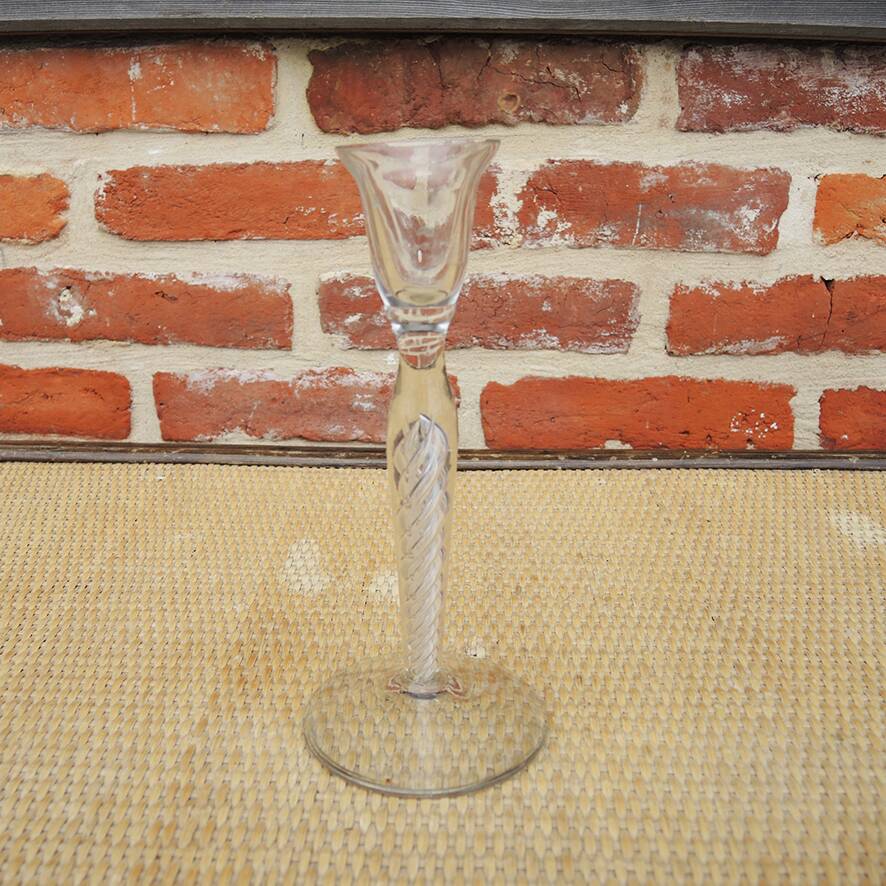 Old twisted transparent glass candlestick
