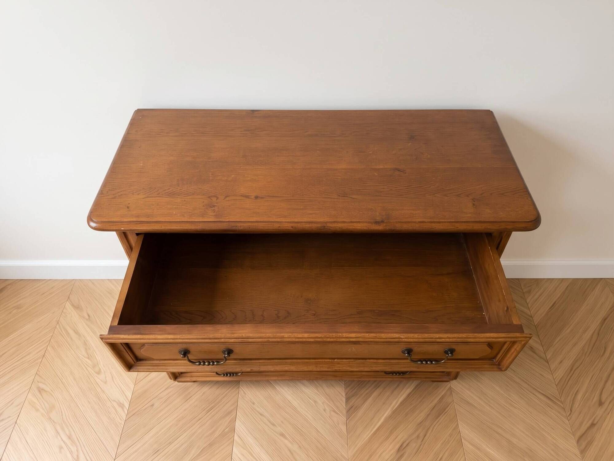 Antique wooden chest of drawers with three drawers.