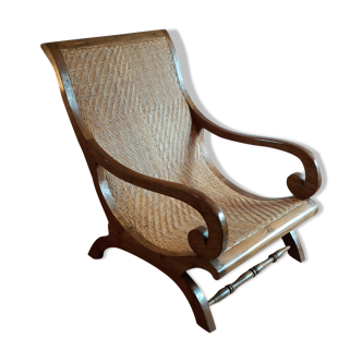 Colonial wicker and antique wood armchair