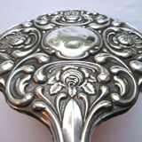 Art Nouveau hand-facing, mirror in repulsed silver frame, rose decoration 14x27cm