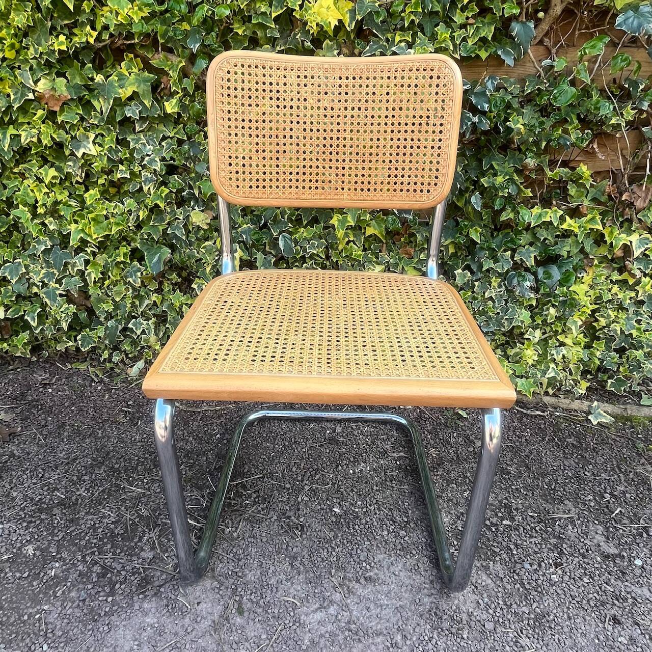 Wooden chair with caning in the style of Marcel Breuer.