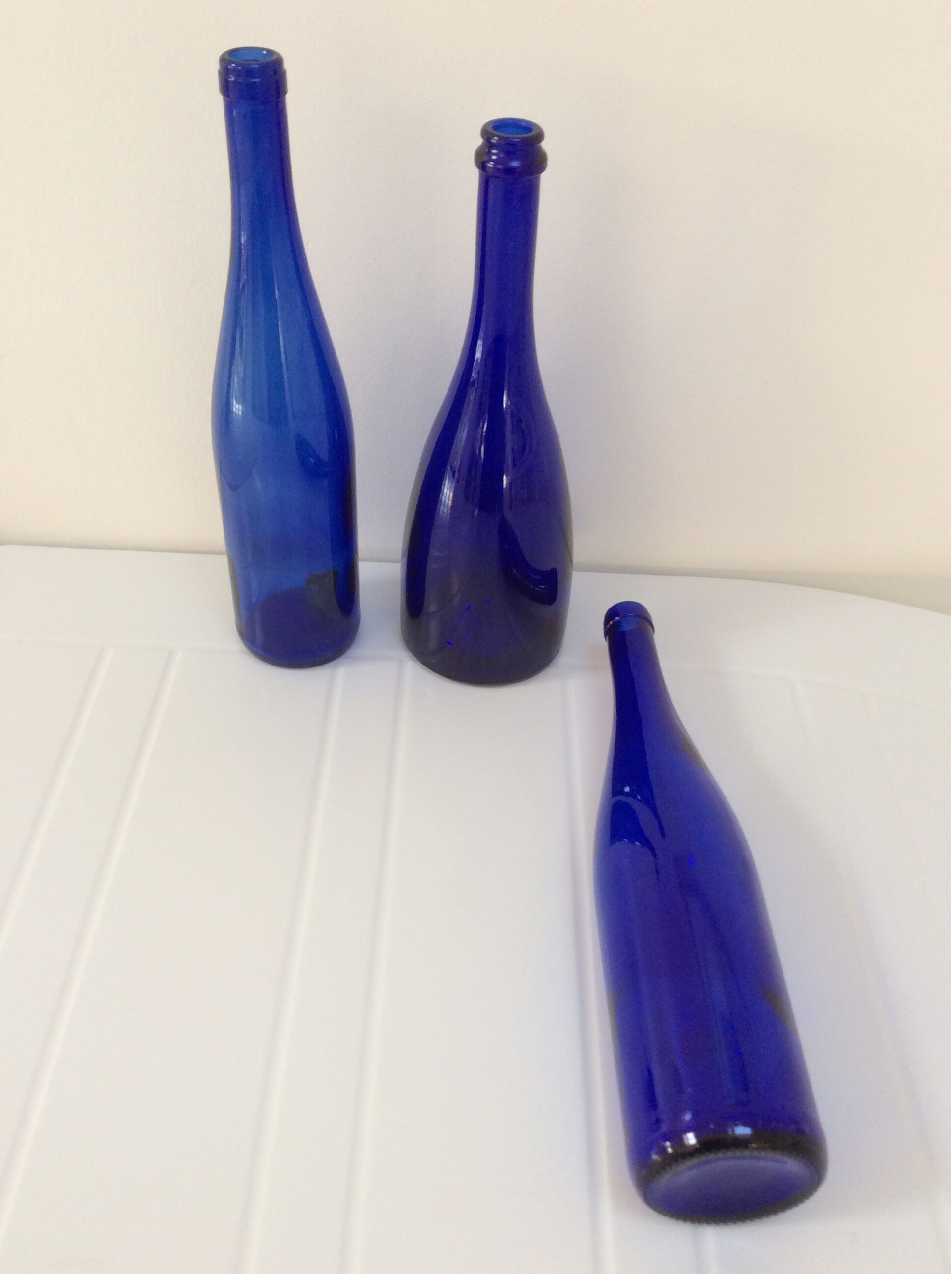 Decorative trio of old blue glass bottles