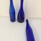 Decorative trio of old blue glass bottles
