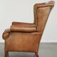 Sheepskin wingback armchair in a light cognac colour in English style