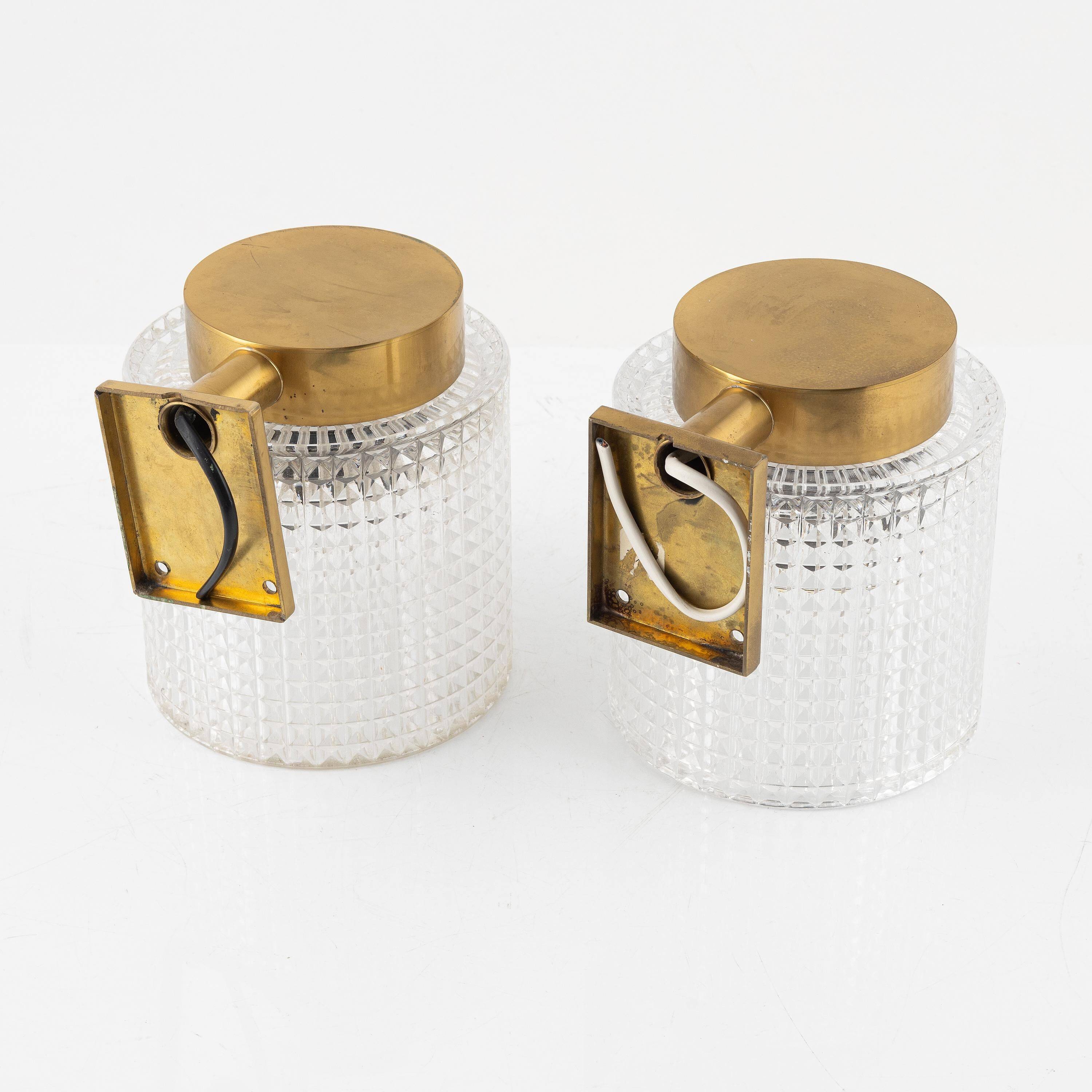 Carl Fagerlund for Orrefors Pair of wall lights in brass and glass Sweden 1960