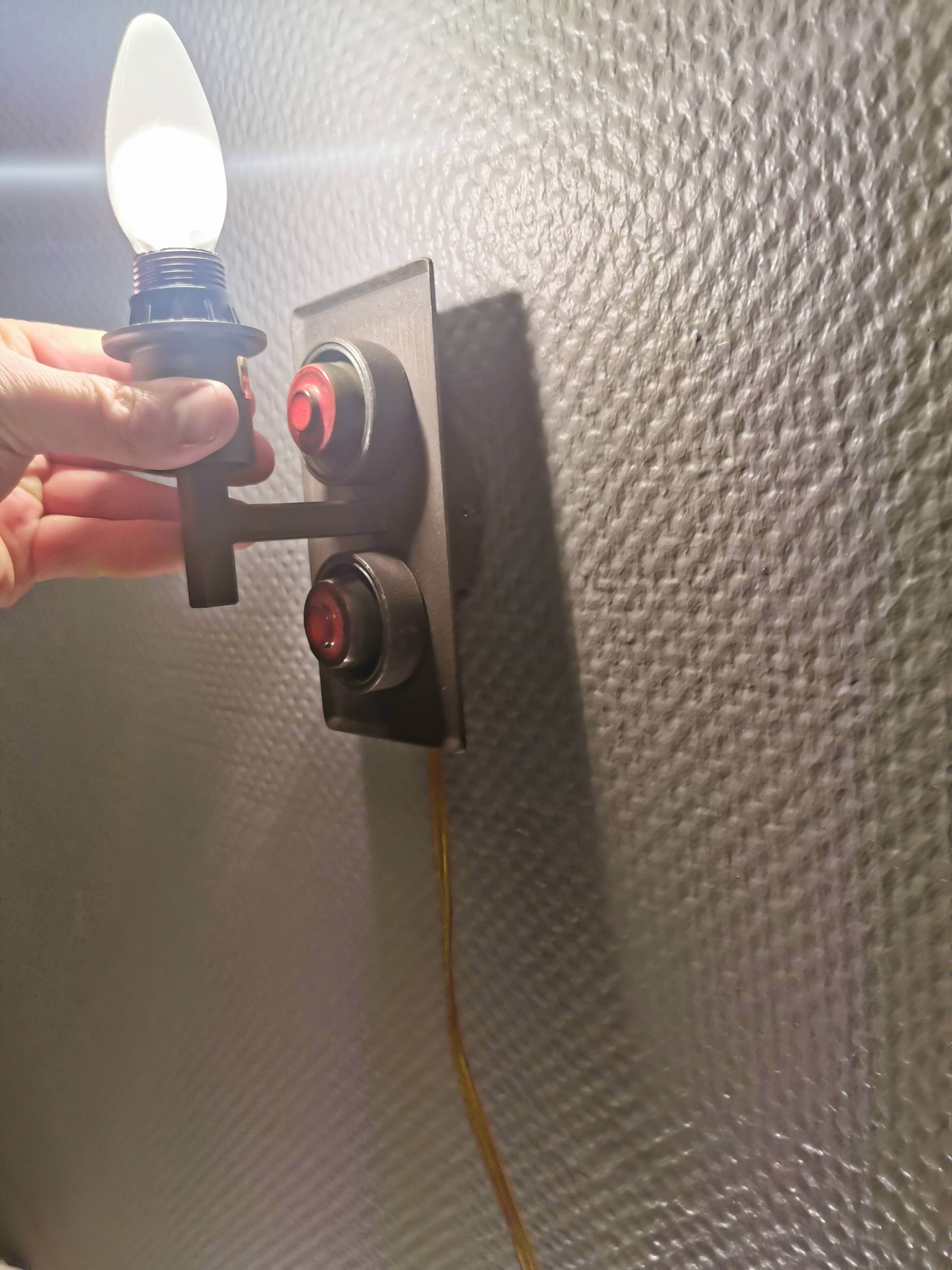 A set of Vitrika Denmark, cast iron wall lights with red details.