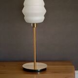 Table lamp with a vintage white glass globe and a golden base