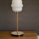 Table lamp with a vintage white glass globe and a golden base