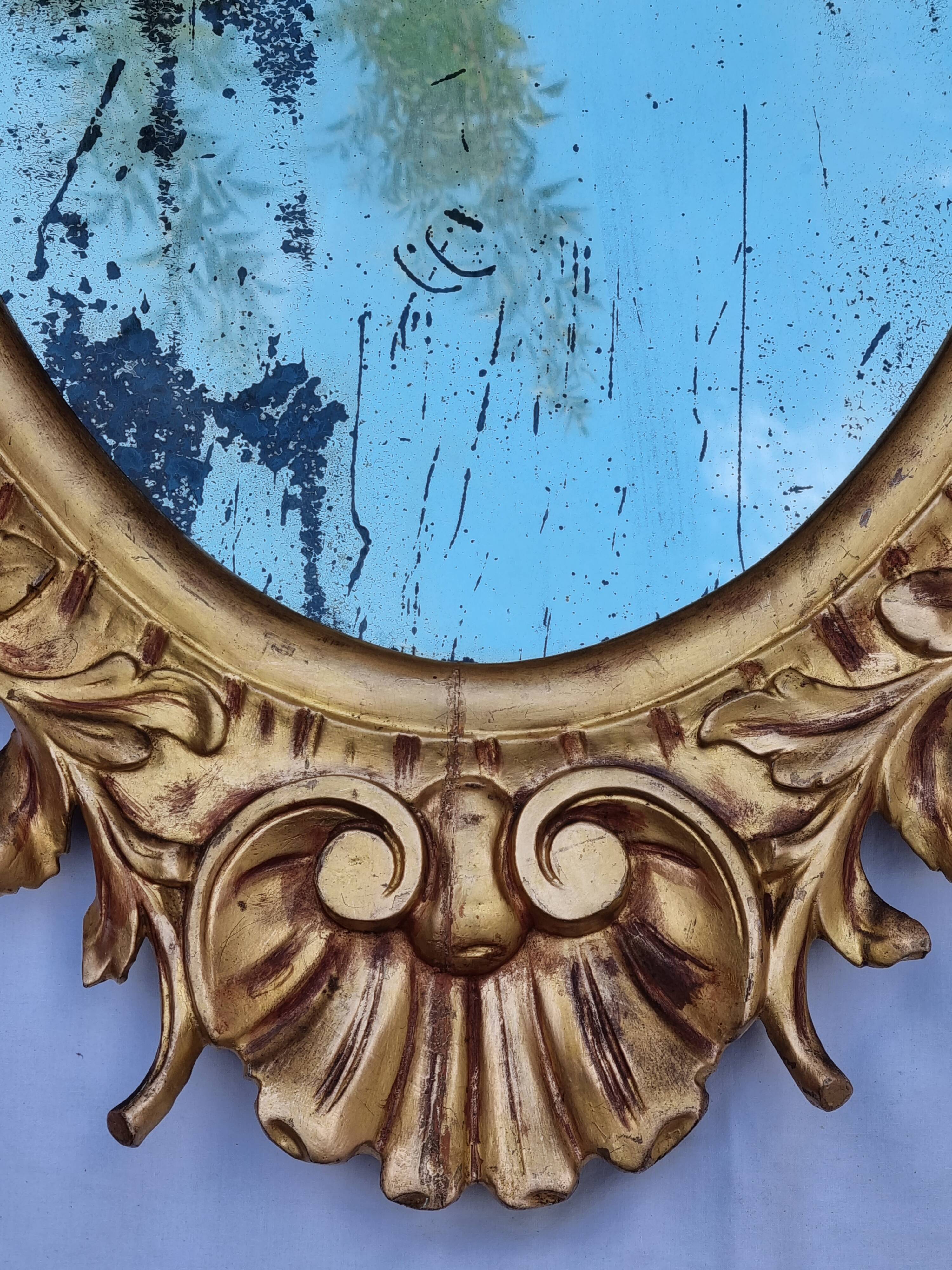 Large oval gold mirror, Louis XV rococo style, late 19th century, 114 x 66 cm.