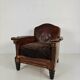 Antique leather club chair with stud detailing