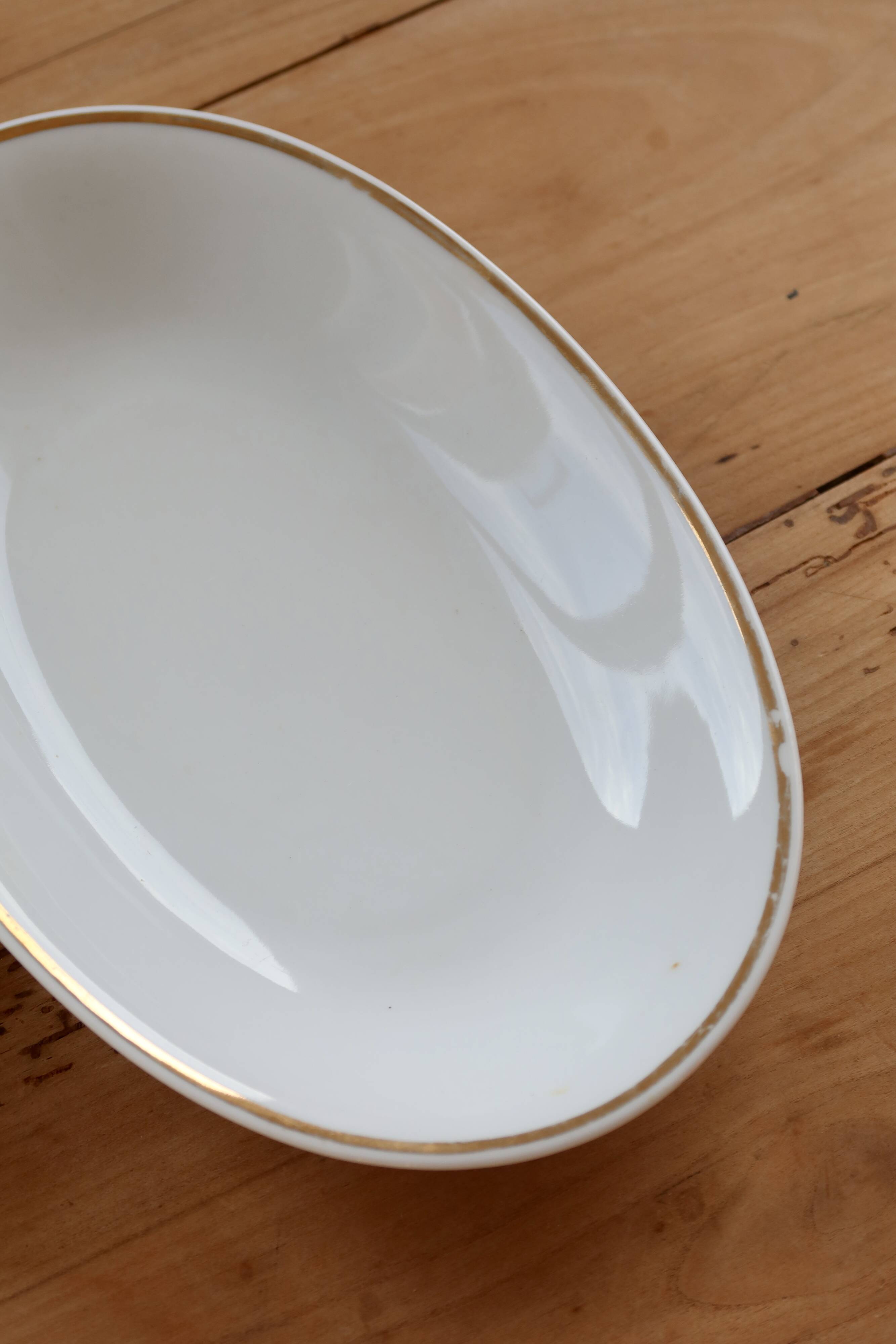 Vintage white porcelain trays with a golden rim.