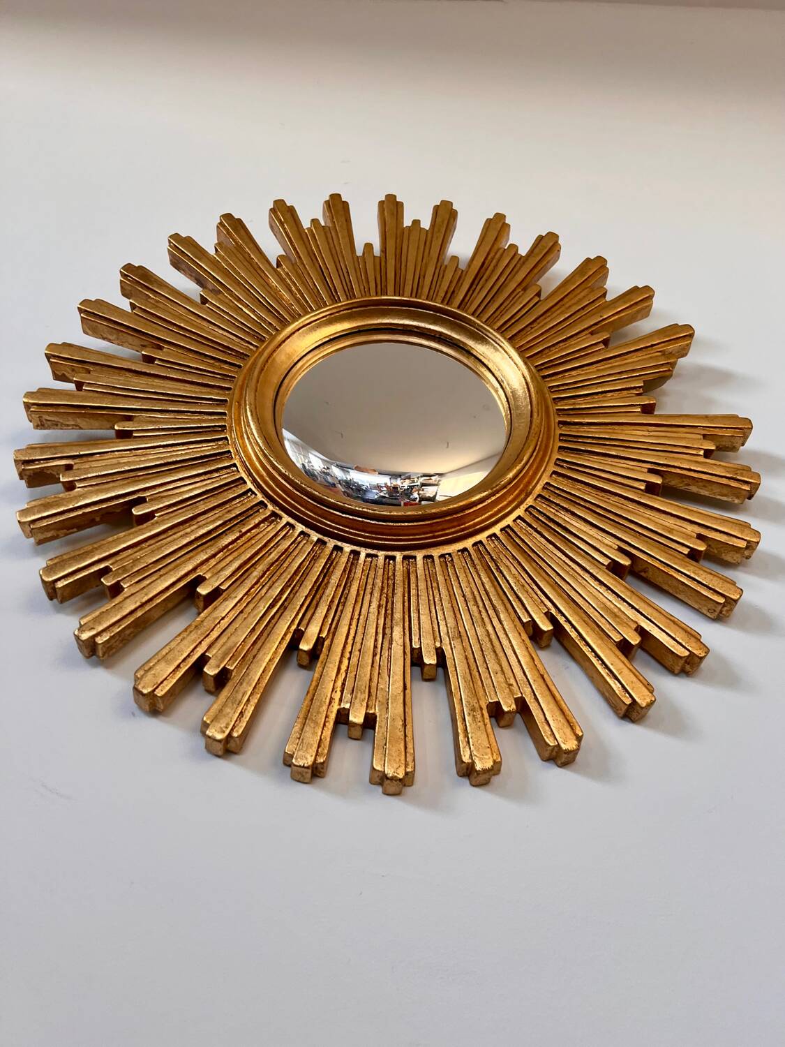 Old large golden sun mirror with rounded witch's eye in vintage resin from the 70s