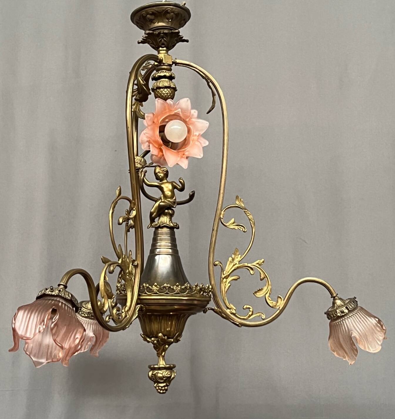 Renaissance chandelier with putti statuette.