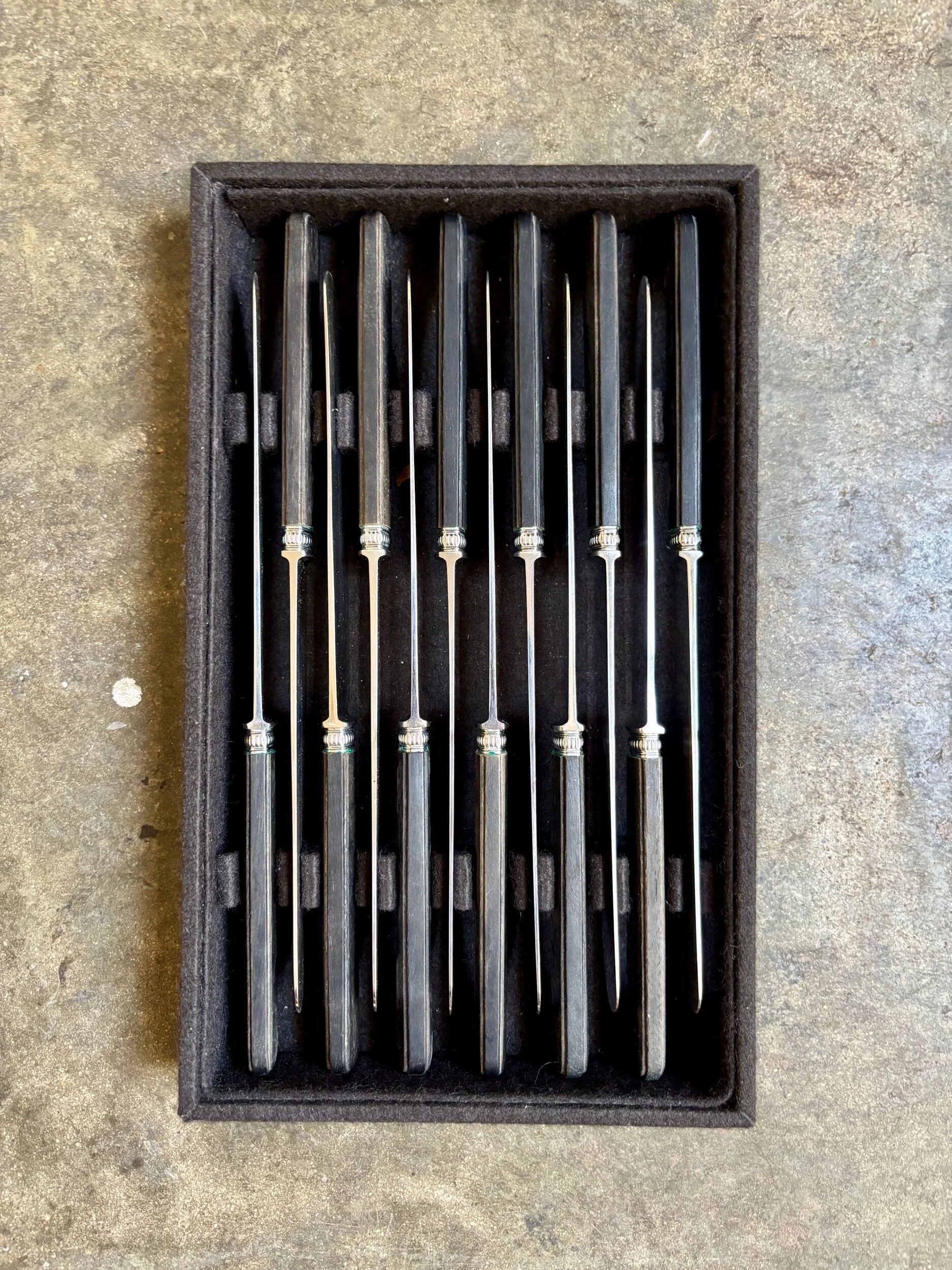 12 blackened wooden knives