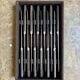 12 blackened wooden knives