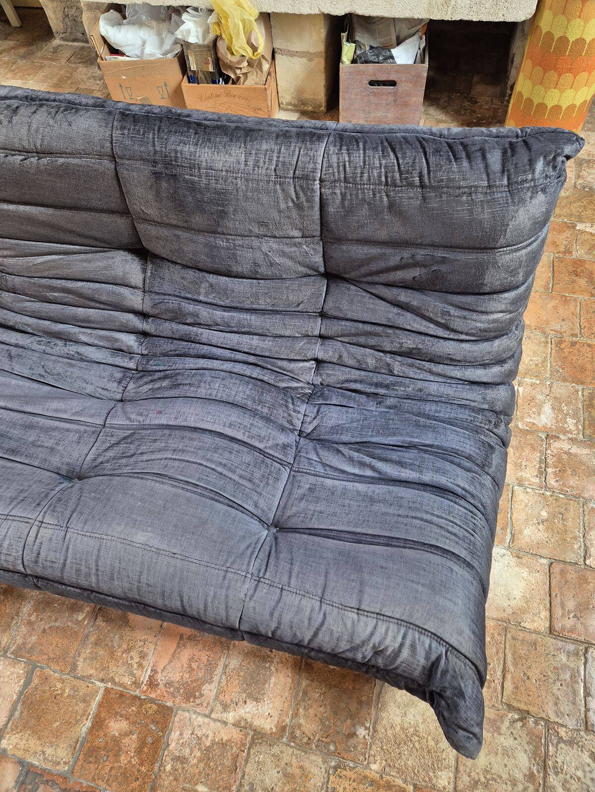 Togo sofa by Ligne Roset and its pouf from the 1970s.