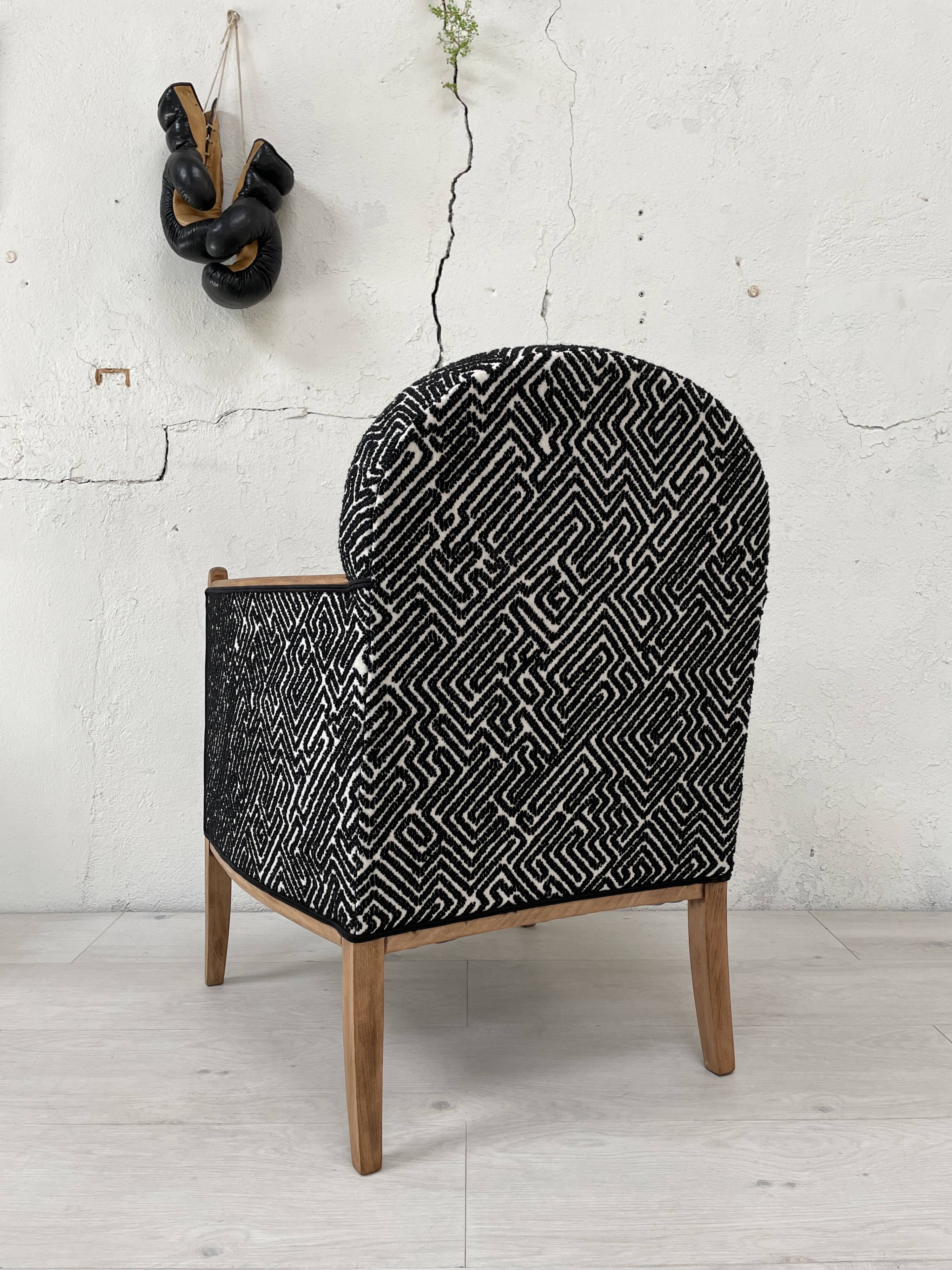 Club armchair in wood and fabric.