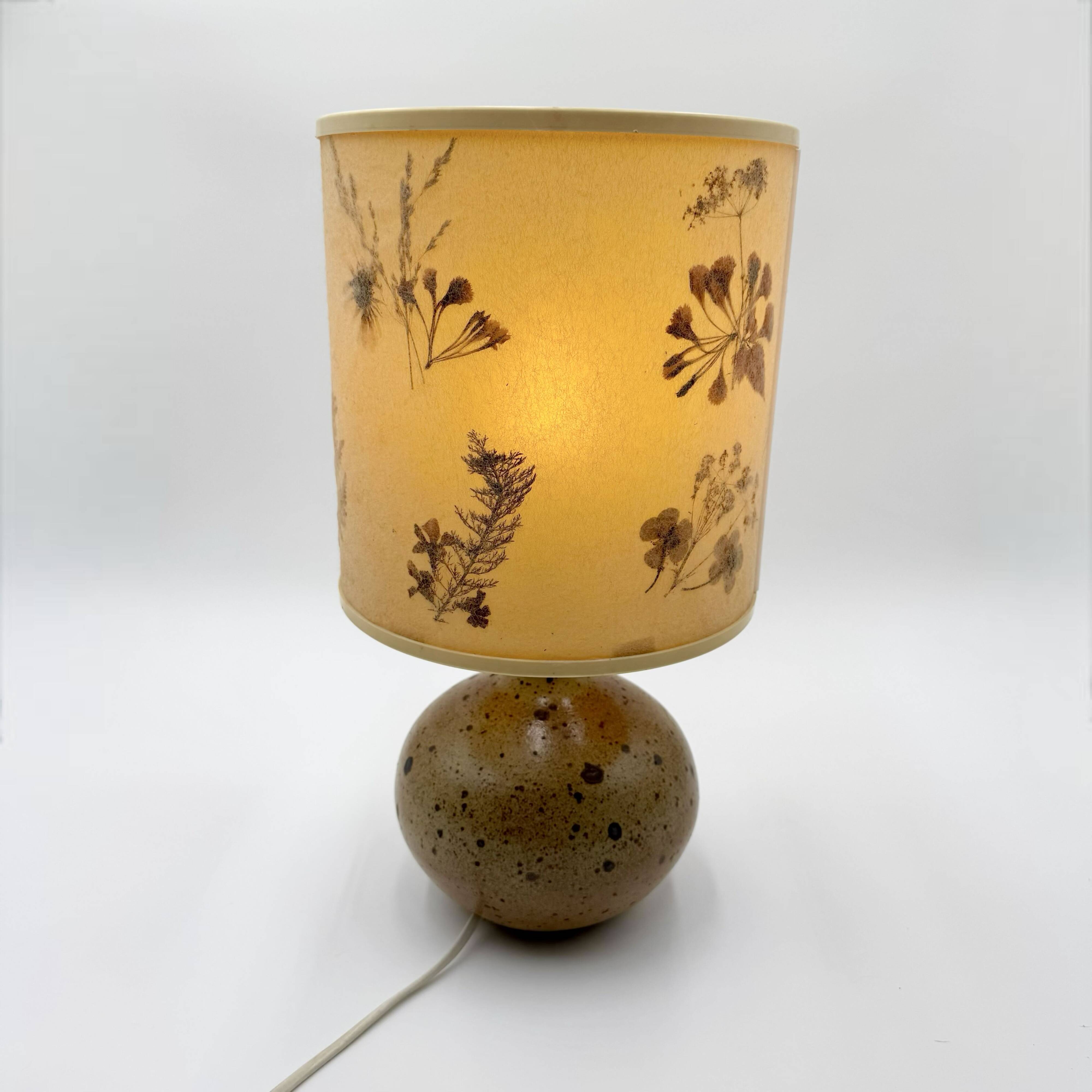 Pyrite stone ball lamp with a lampshade featuring dried flower inclusions.