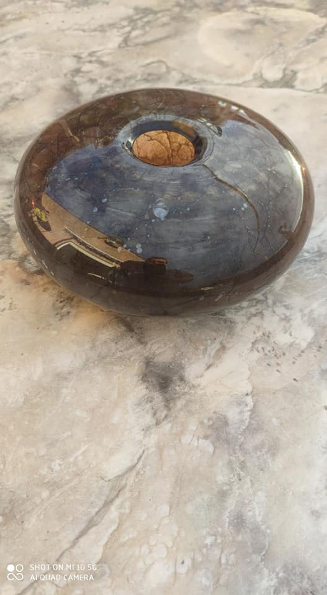 Flattened spherical vase made of glass paste