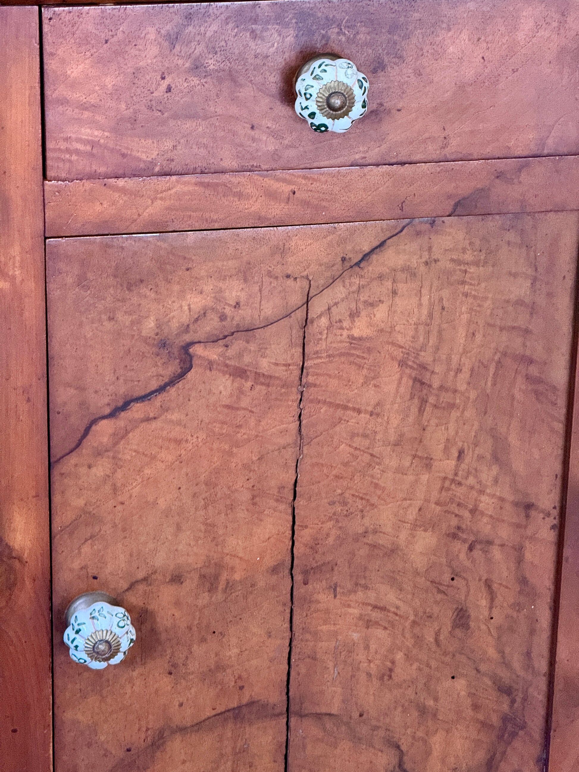 Wood and marble side table with ceramic handles.