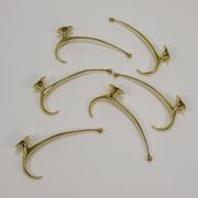 Two curved wall coat racks in brass by Franz Hagenauer, Vienna, mid-20th century, 1950s.