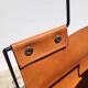 Magazine rack in tan leather and black metal