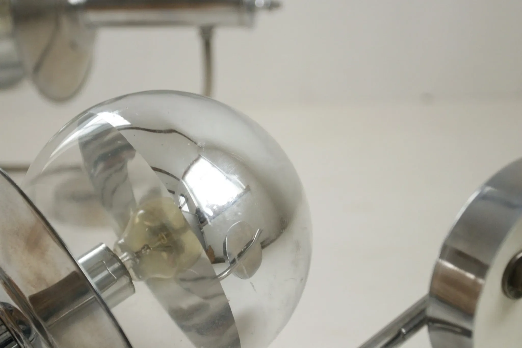 Pair of European mid-century chrome wall sconces with mirrored globe shades