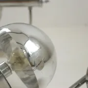 Pair of European mid-century chrome wall sconces with mirrored globe shades