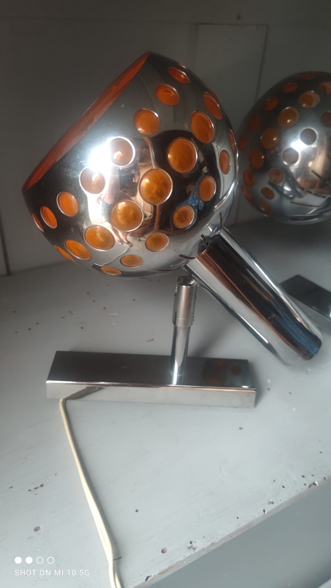 Pair of chrome-plated metal wall lights with adjustable ball joints, circa 1970